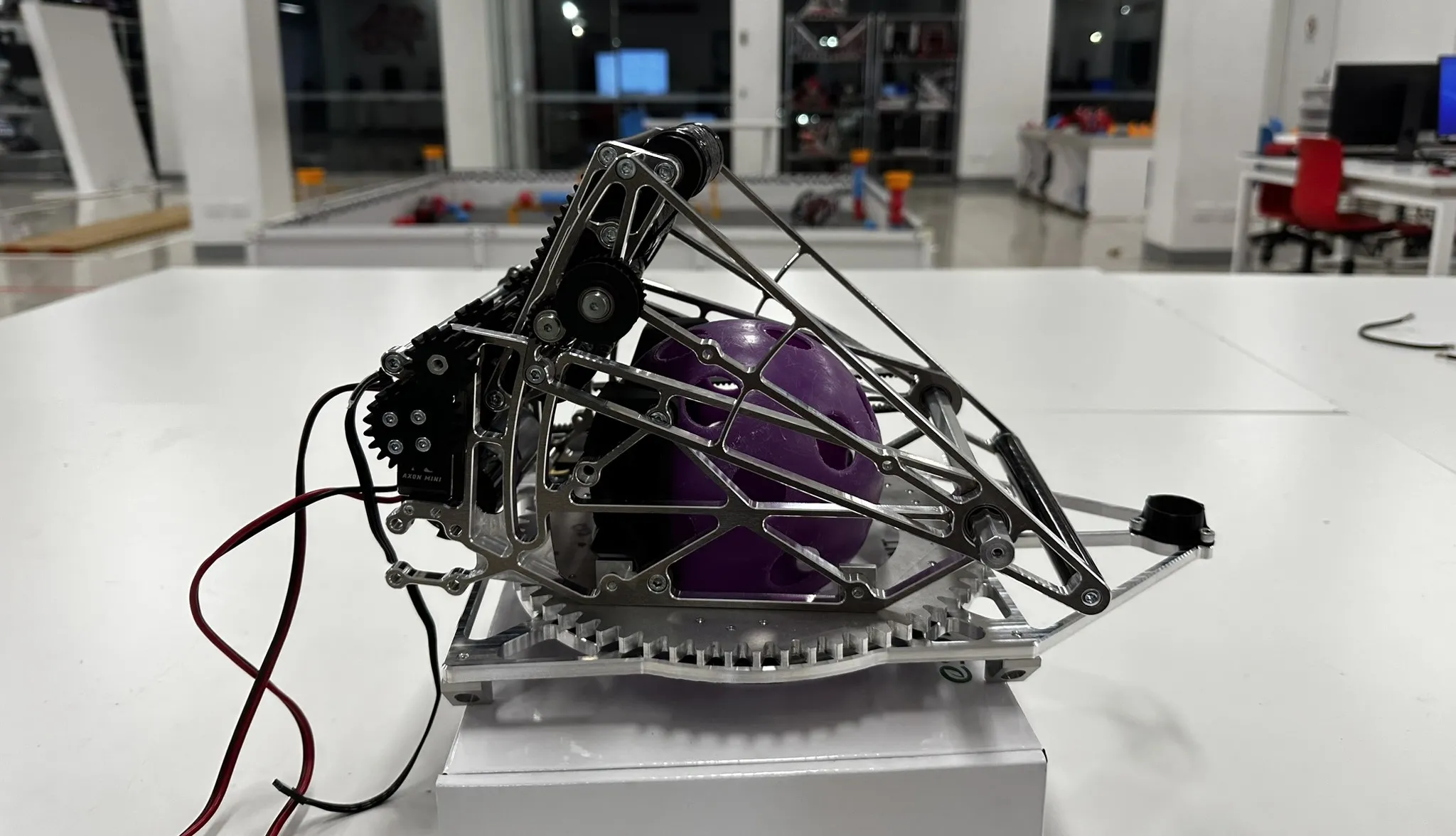 Assembled adjustable-angle back-roller shooter and turret holding a ball