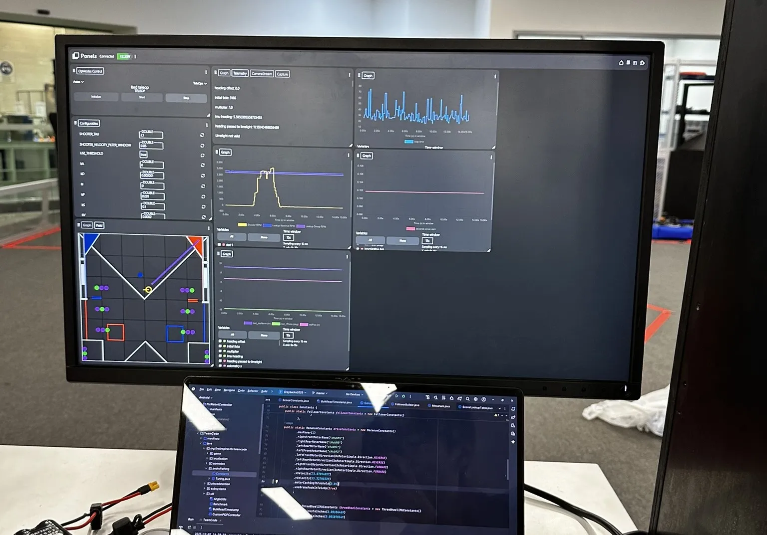 Development dashboard graphing selected robot telemetry values beside the source code